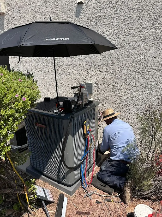 HVAC technician performing outdoor AC maintenance in Collierville