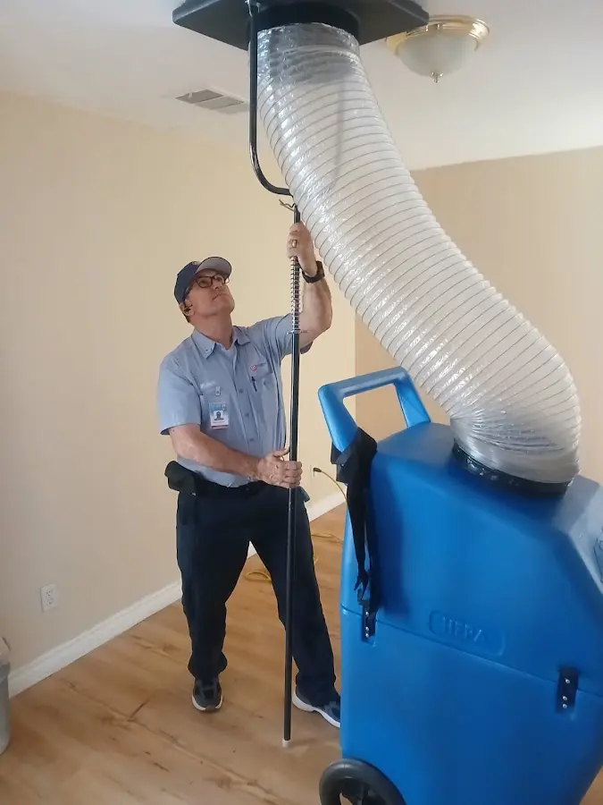 Furnace Tune-Up technician using HEPA equipment in Collierville
